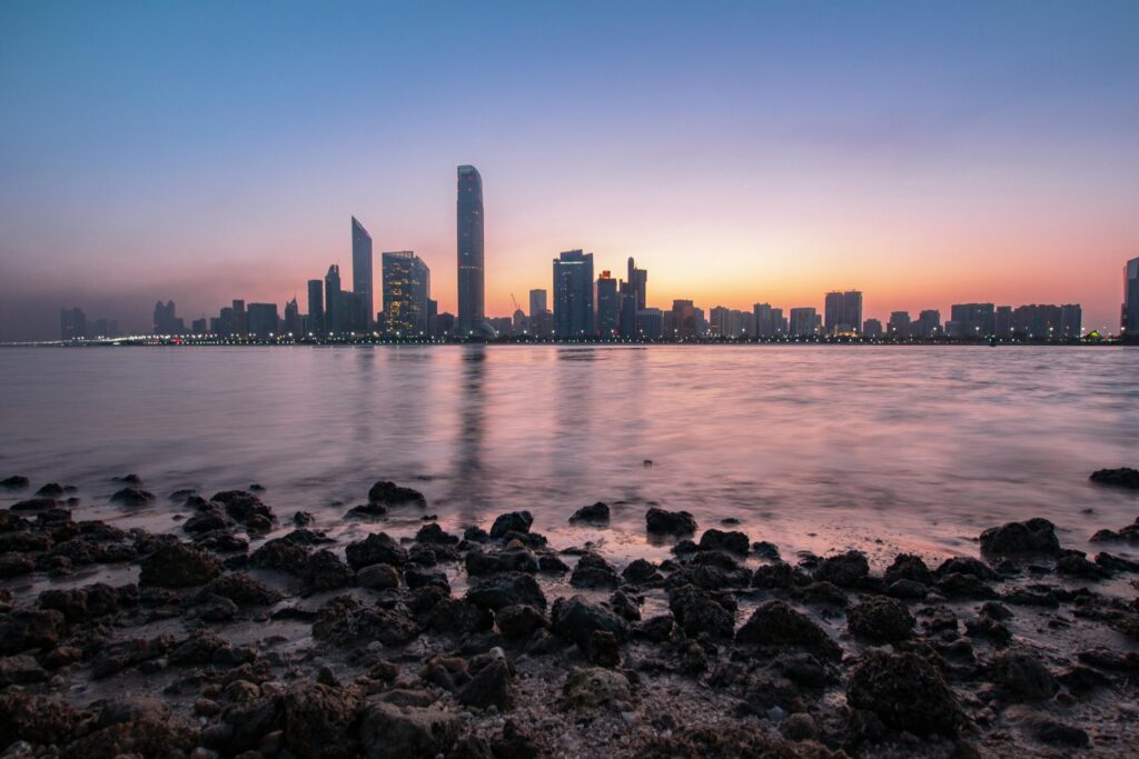 A distant view of Abu Dhabi cityscape and buildings, captured from across the river.