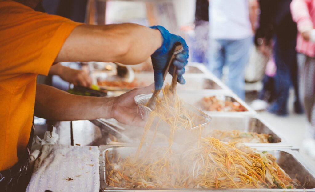 A food stall owner packing a customer's order in Bali