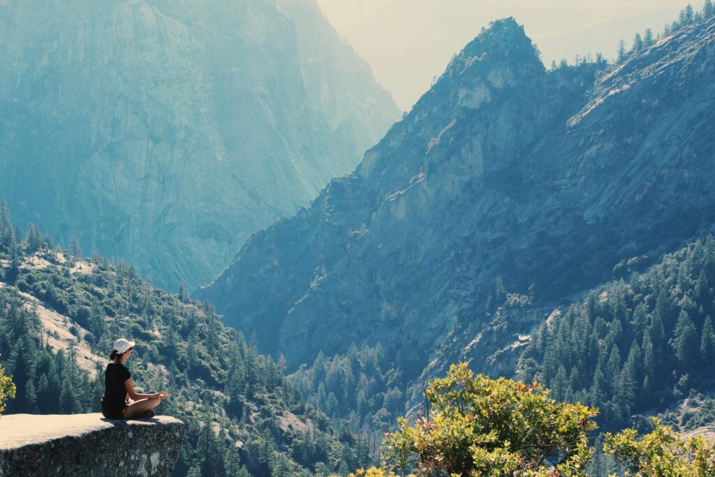 Image of A woman meditating in the mountains