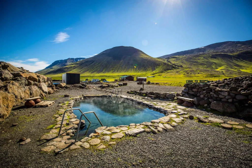 "Geothermal pool in Iceland with vibrant sunset in the background